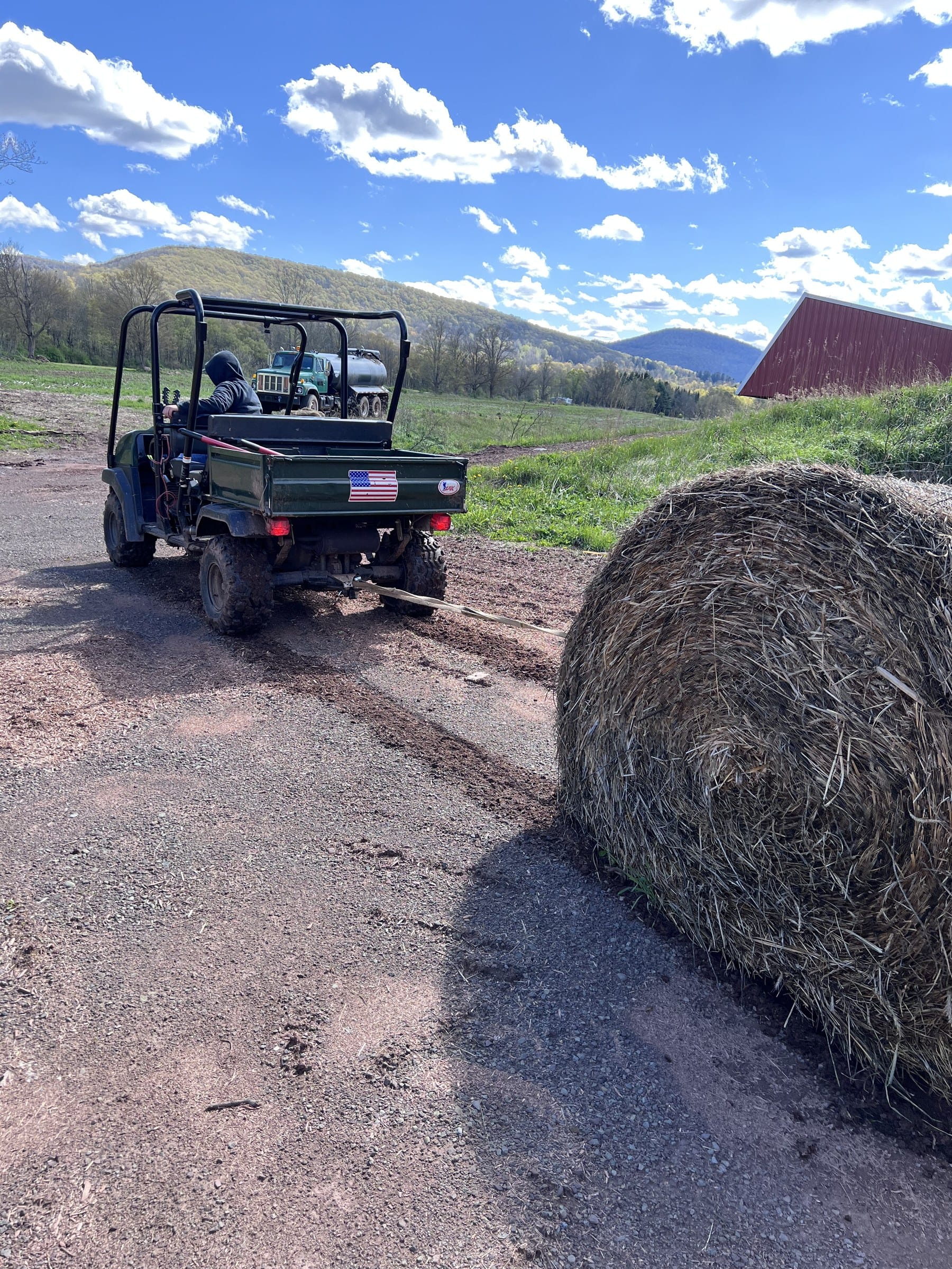 Ashridge farm acreage — hay move along the barn road with red gambrel roof beyond, South Kortright, New York