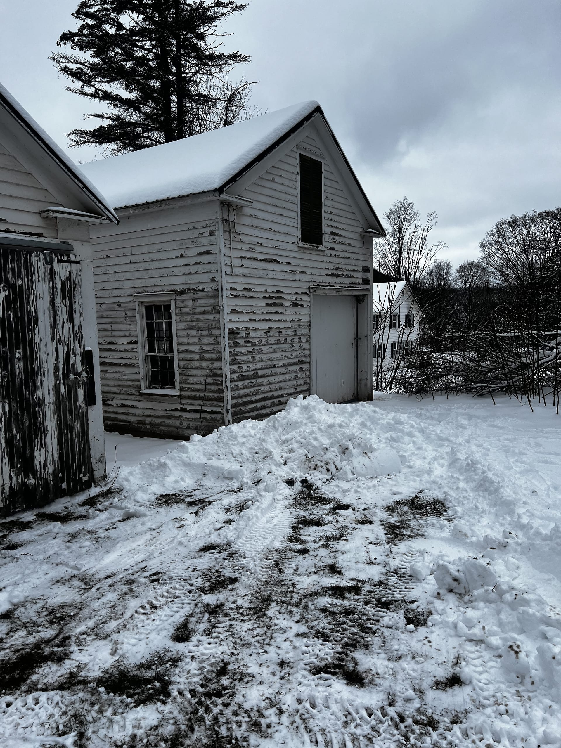 Ashridge Estate outbuildings in winter — connected historic sheds with farmhouse beyond