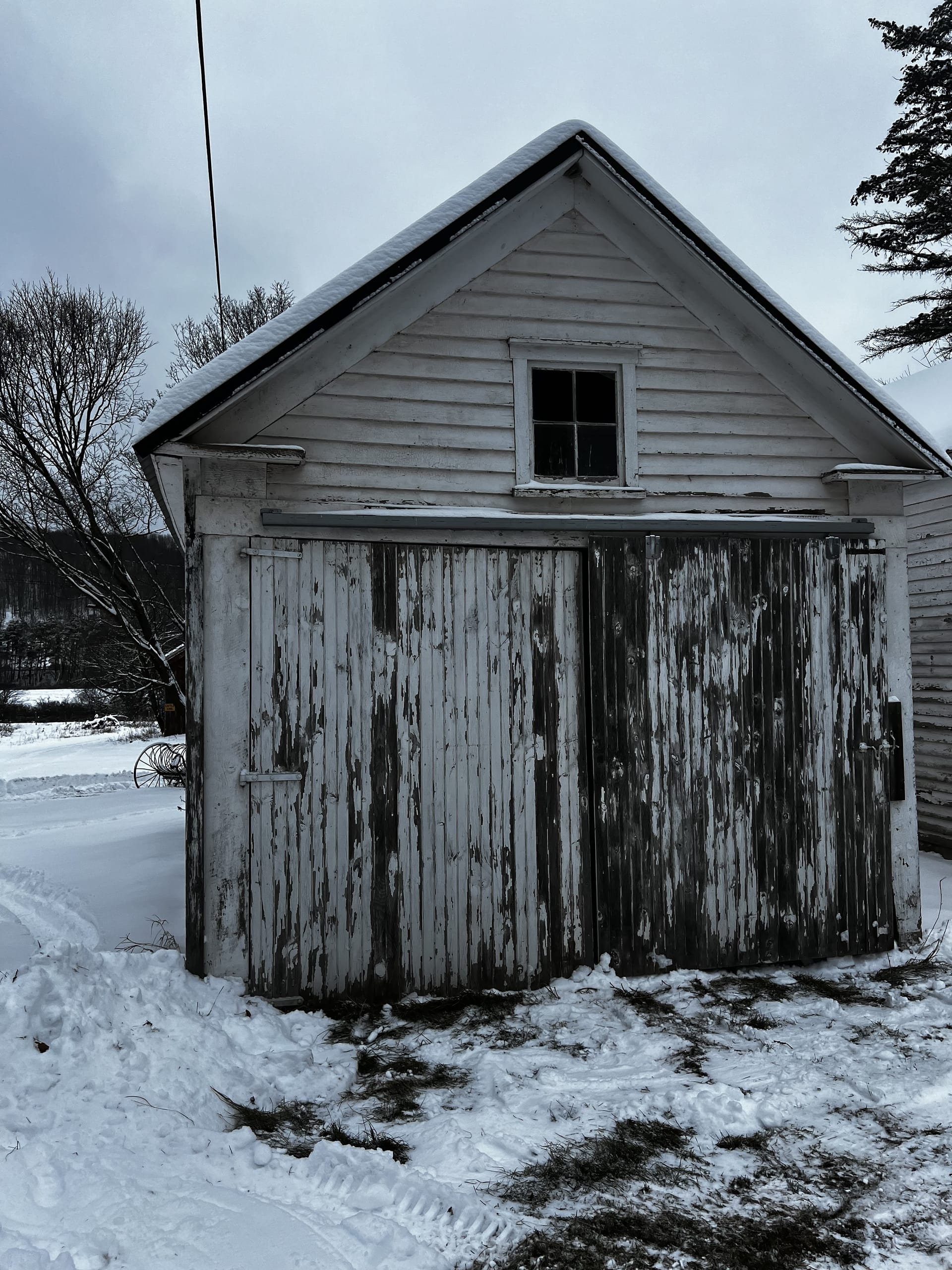 Ashridge Estate white outbuilding in winter — historic clapboard shed with weathered patina, South Kortright