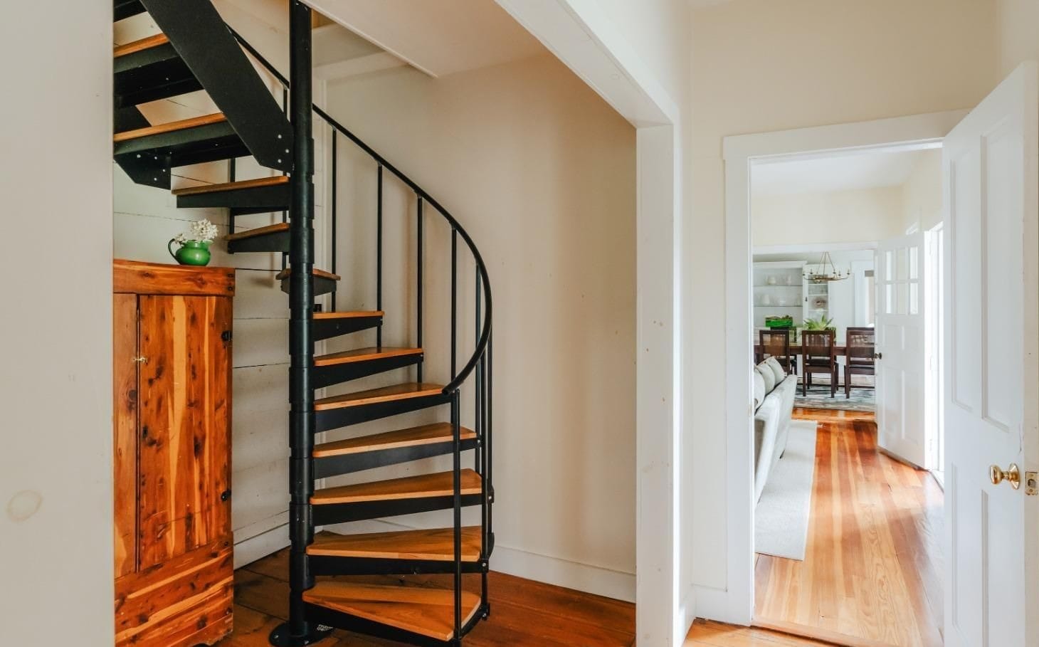 Farmhouse entry hall at Ashridge Estate — spiral staircase and view through to the dining room, South Kortright, New York