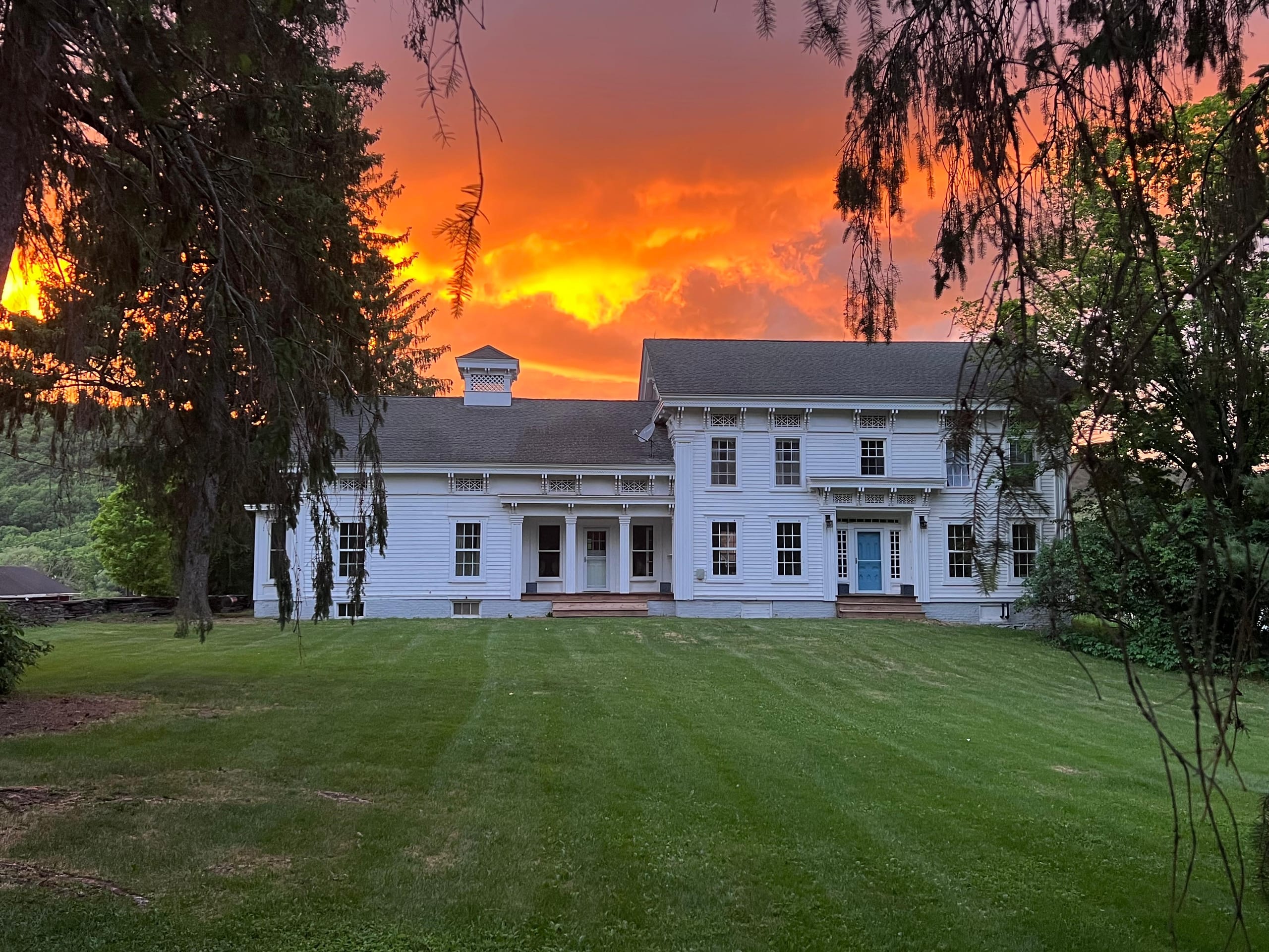 Seven-bedroom Greek Revival farmhouse at Ashridge Estate at sunset, South Kortright, New York