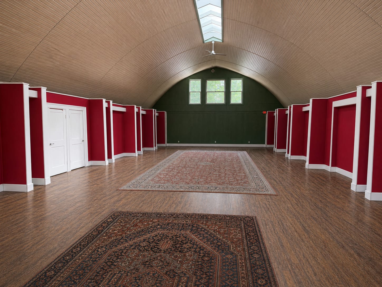 Ashridge gallery hall — barrel-vaulted upper gallery with crimson walls, white pilasters, and natural wood ceiling with skylight