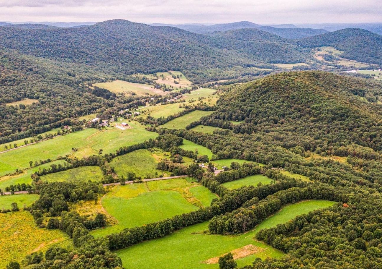 Catskill valley at Ashridge Estate — aerial view of patchwork fields and forested hills, South Kortright, New York