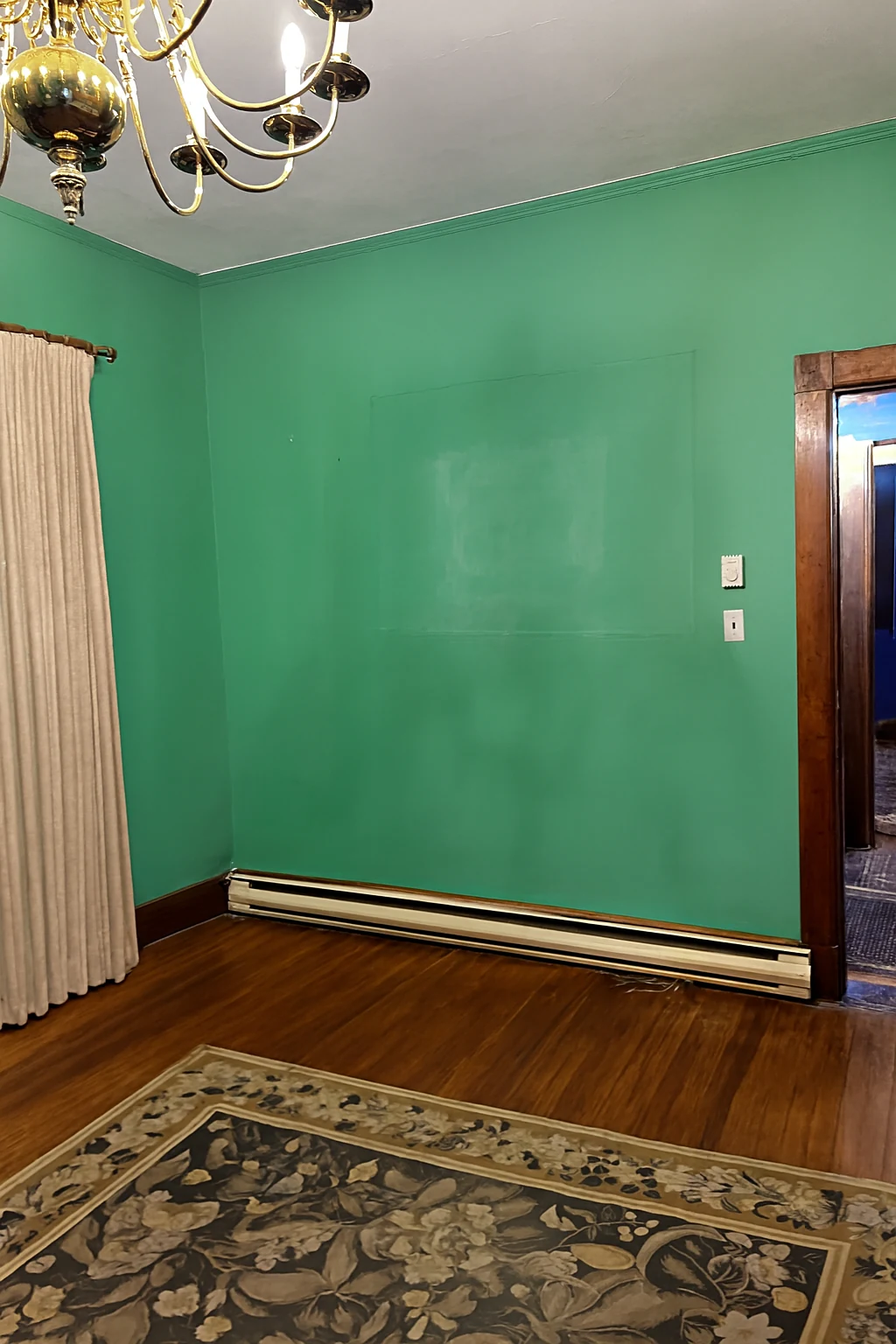 Ashridge mansion green room — cleared interior showing fireplace wall and oak paneling