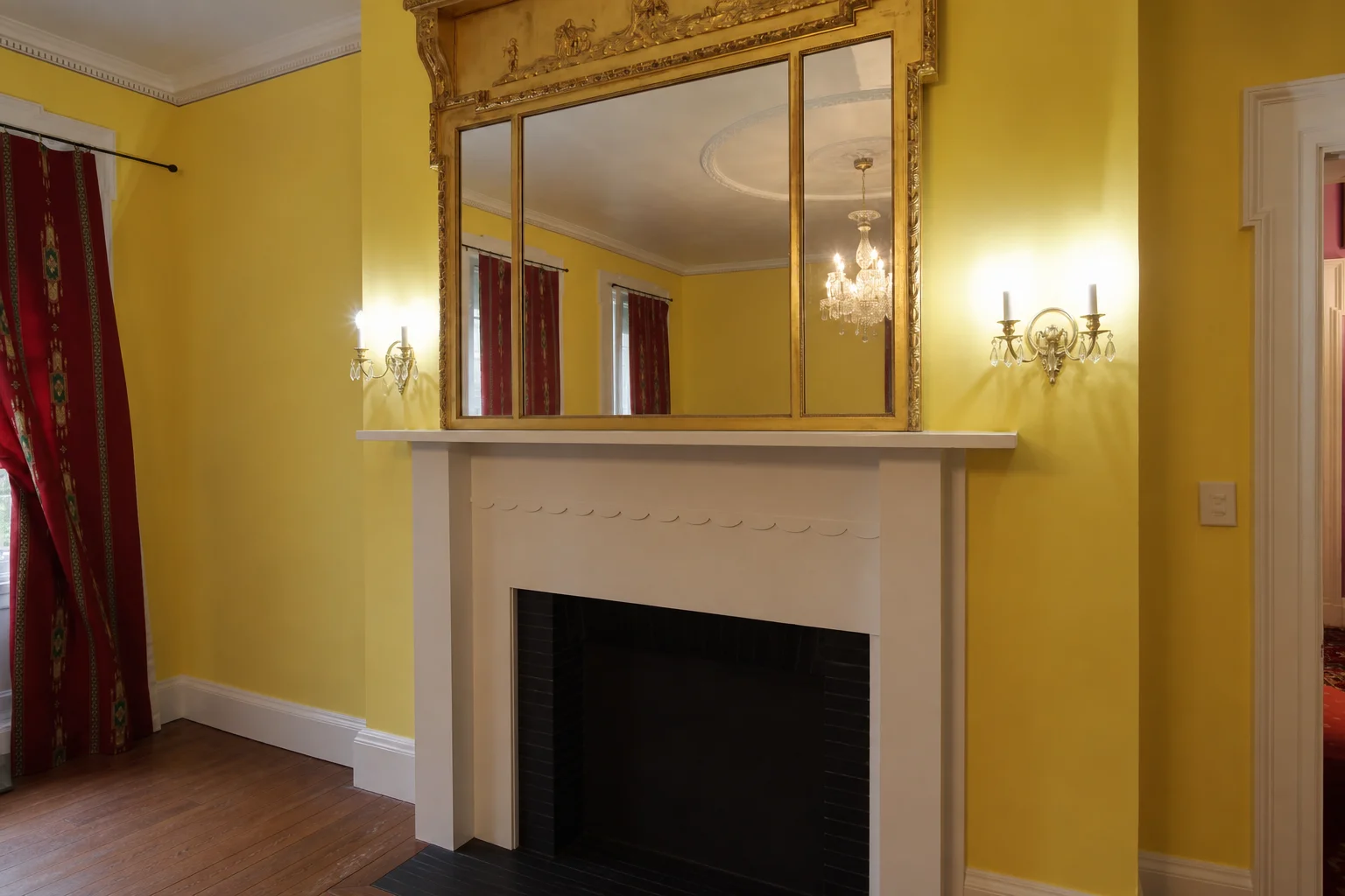 Ashridge mansion yellow parlor — cleared fireplace wall with gilt mirror, sconces, and marble surround